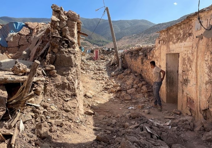 A person stands near damaged houses in Tafeghaghte, a remote village of the High Atlas mountains, following a powerful earthquake in Morocco. (Photo: Reuters)